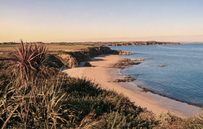 Sandy beach and cliffs on the Wexford coast at sunset