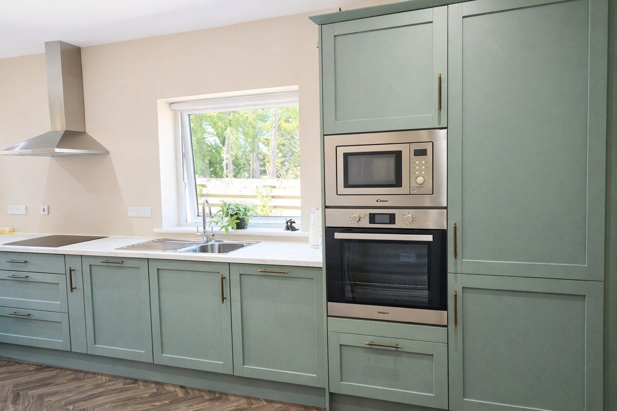 Kitchen with sage cabinets and oven