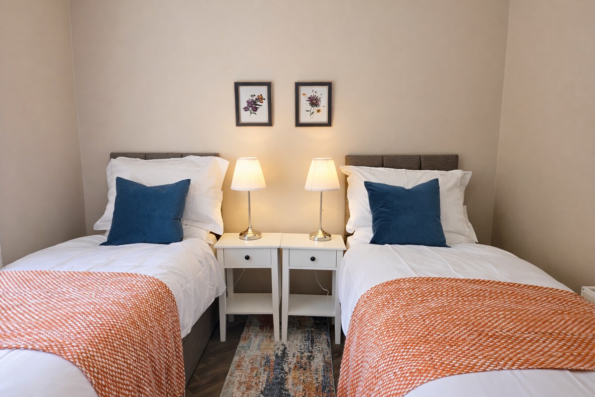 Twin bedroom with blue cushions